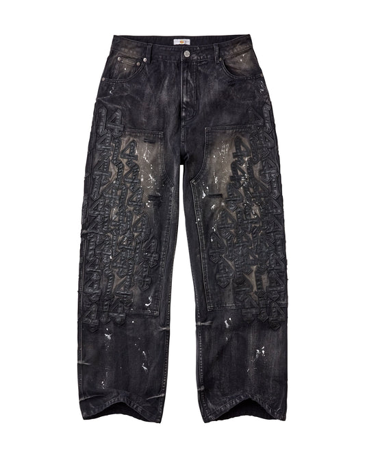 Black washed denim jeans with the number 14 leather patches down both pant legs, and white splatter paint marks on the denim. 